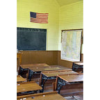 Nylon American Flag - Beacon® hanging on the wall of a vintage classroom with wooden desks and a chalkboard.