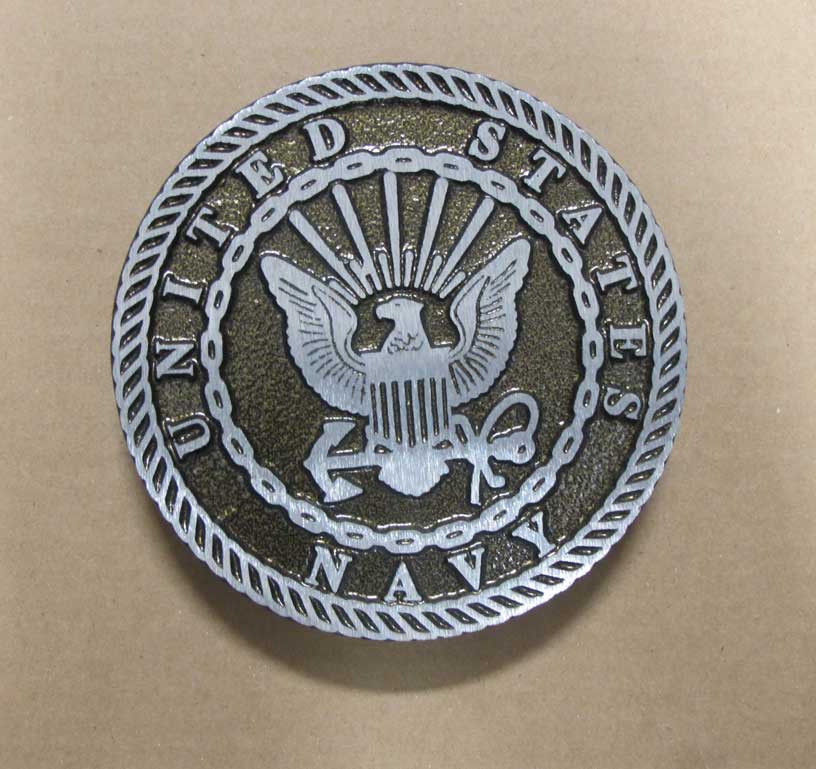 Close-up of a round Aluminum Military Grave Marker featuring the United States Navy emblem with an eagle, anchor, and shield design.
