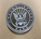 Close-up of a round Aluminum Military Grave Marker featuring the United States Navy emblem with an eagle, anchor, and shield design.