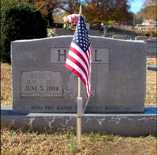 grave marker with flag and flowers