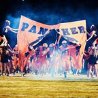 football players running flag entra