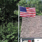 American flag flying by house