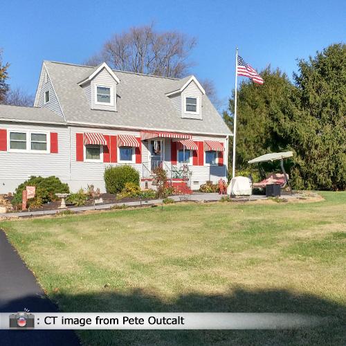 house with flag and landscaping