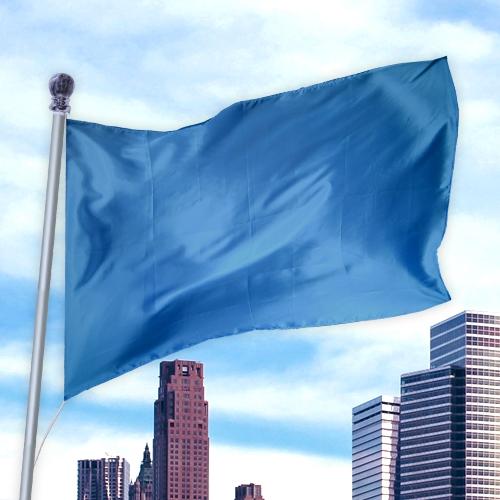 Blue flag made of durable premier nylon fabric waving on a pole against a city skyline background, Solid Colored Flags - Premier Nylon