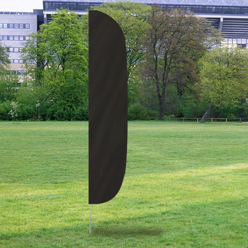 Solid Color Flutter Flags in black standing upright on a grassy field with trees and buildings in the background