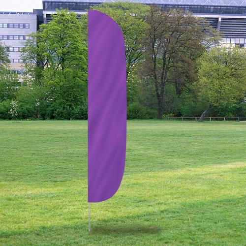 Solid Color Flutter Flags in vibrant lavender purple displayed outdoors on a grassy field with trees and buildings in the background.