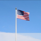 USA flag flying against blue sky