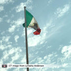 Mexican flag against blue sky