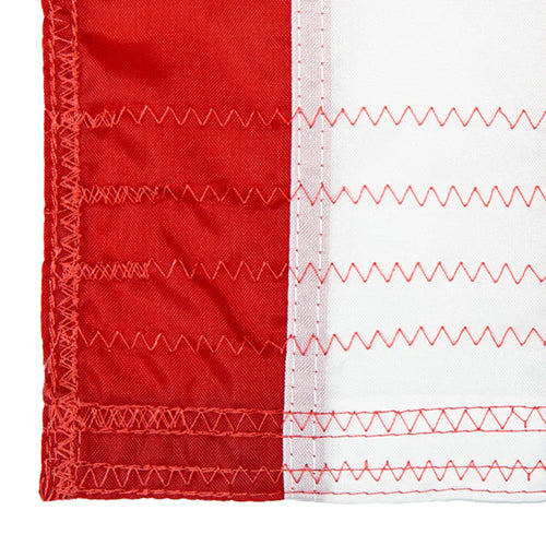 Close-up of red and white reinforced stitching on durable fabric edge showcasing the quality of Texas Extreme Reinforced Outdoor Flags.