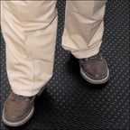feet in brown shoes on black mat