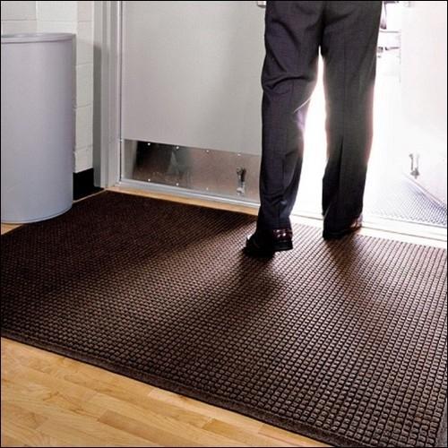 man standing on rug by doorway