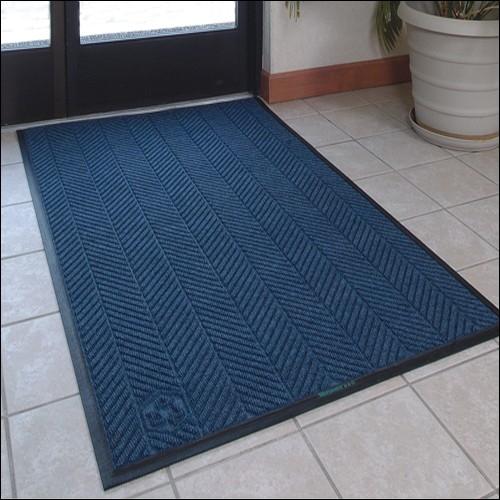blue woven door mat on tile floor